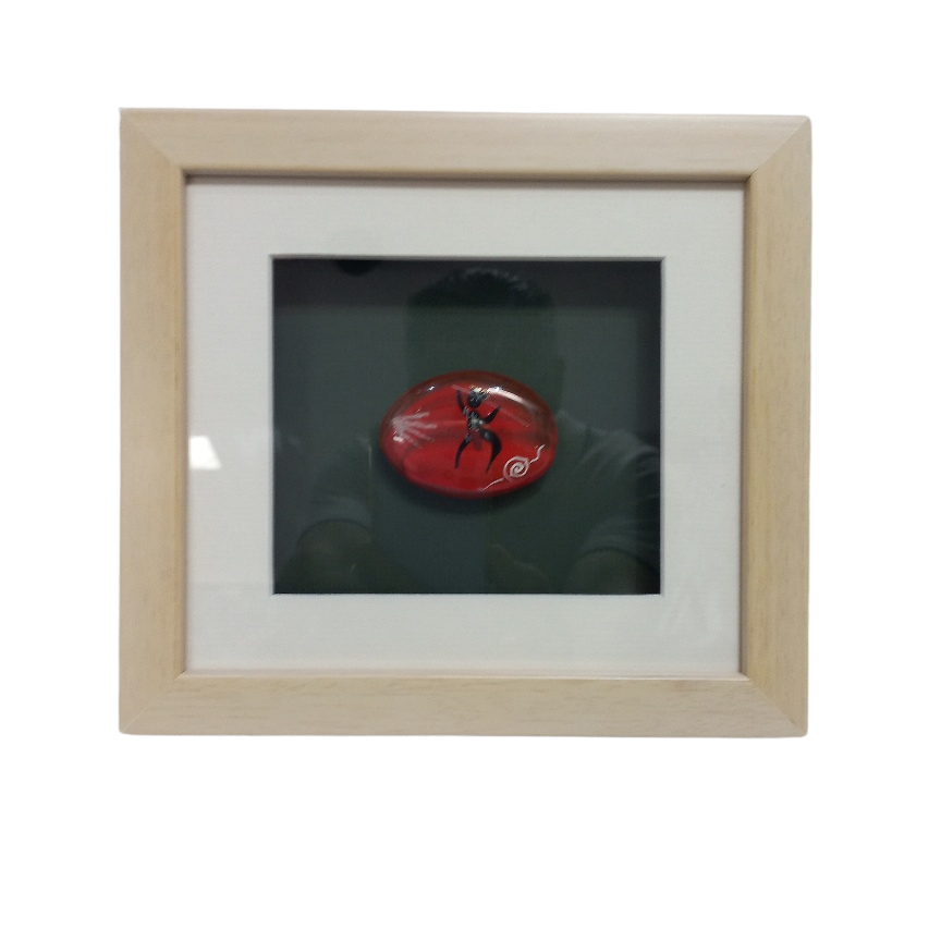large hand painted stone in frame